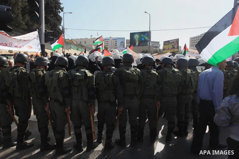 Palestinian security forces stand guard during a protest against the visit of the US Secretary of State John Kerry and peace negotiations, in the West Bank city of Bethlehem, 06 November 2013. Kerry began a day of meetin...