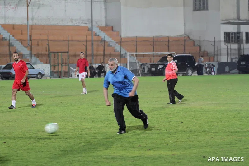 Palestinian Prime Minister in Gaza Strip Ismail Haniyeh (blue T-shirt) participates in a soccer match with veterans players marking the anniversary of the Balfour Declaration, in Gaza City on November 06, 2013. Balfour d...