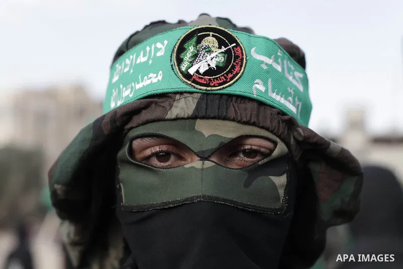 A Member of the Palestinian Islamist movement Hamas poses during an anti-Israel march on the first anniversary of Israel's Operation Pillar of Defence on November 8, 2013 in the al-Nuseirat refugee camp, in central Gaza...