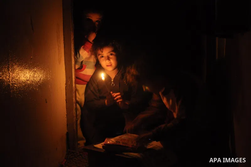 Palestinian children study on candles light during a power cut in Al-Shatea' refugee camp in Gaza City on November 8, 2013. Gaza's lone power plant shut its generators on Friday due to a fuel shortage, a move that will l...
