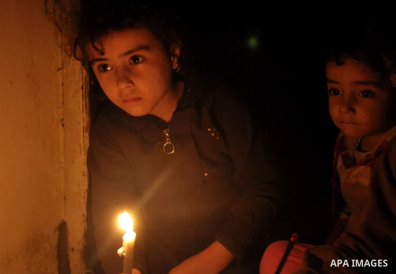Palestinian children study on candles light during a power cut in Al-Shatea' refugee camp in Gaza City on November 8, 2013. Gaza's lone power plant shut its generators on Friday due to a fuel shortage, a move that will l...