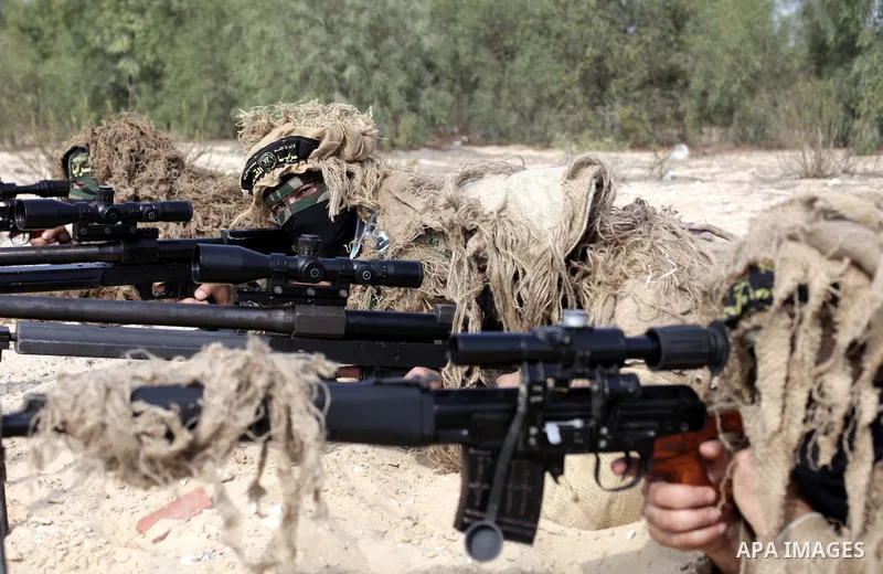 Palestinian special forces of snipers unit belonging to the al-Quds Brigades, the armed wing of the Islamic Jihad organization, aim during military training on the first anniversary of Israel's Operation Pillar of Defenc...