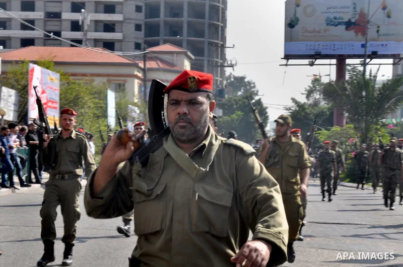 Members of the Palestinian security forces march along the streets in Gaza City on November 13, 2013, ahead of the first anniversary an Israeli army operation which was launched after the killing of top Palestinian milit...