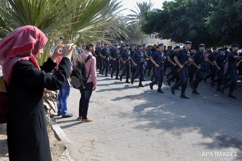 Members of the Palestinian security forces march along the streets in Gaza City on November 13, 2013, ahead of the first anniversary an Israeli army operation which was launched after the killing of top Palestinian milit...