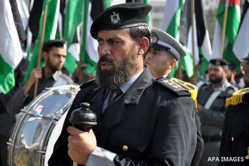 Members of the Palestinian security forces march along the streets in Gaza City on November 13, 2013, ahead of the first anniversary an Israeli army operation which was launched after the killing of top Palestinian milit...