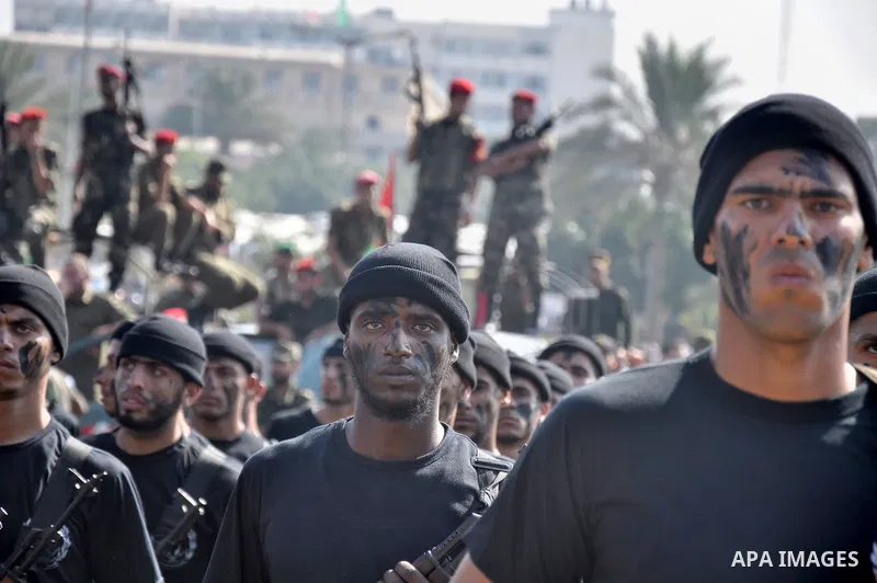 Members of the Palestinian security forces march along the streets in Gaza City on November 13, 2013, ahead of the first anniversary an Israeli army operation which was launched after the killing of top Palestinian milit...