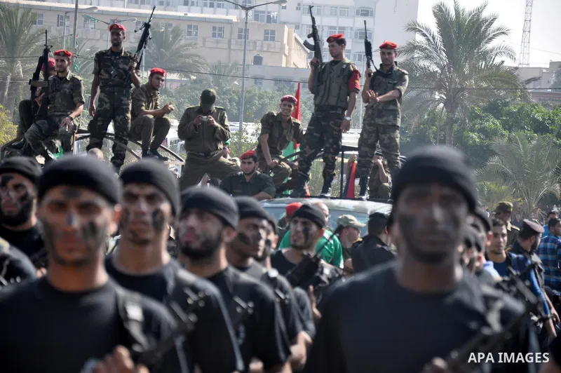 Members of the Palestinian security forces march along the streets in Gaza City on November 13, 2013, ahead of the first anniversary an Israeli army operation which was launched after the killing of top Palestinian milit...