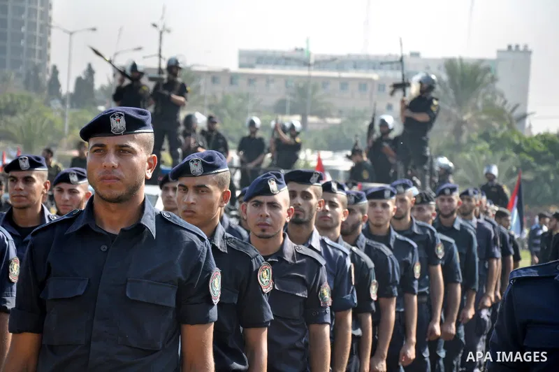 Members of the Palestinian security forces march along the streets in Gaza City on November 13, 2013, ahead of the first anniversary an Israeli army operation which was launched after the killing of top Palestinian milit...