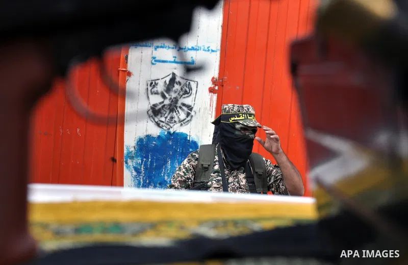 Members of al-Quds brigades, the military wing of Jihad Islamic organisation march along the streets in Gaza City on November 13, 2013, ahead of the first anniversary an Israeli army operation which was launched after th...