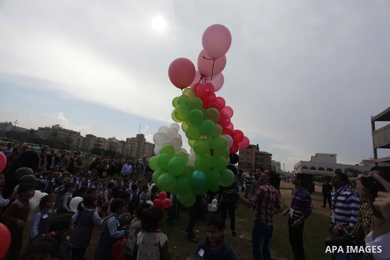 Palestinians hold balloons in the colour of the national flag to mark the 25th anniversary of the Palestinian Independence Day, in Gaza city, on Nov. 17, 2013. Palestinians have marked Nov. 15 as their Independence Day s...