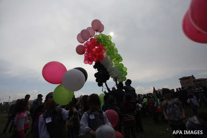 Palestinians hold balloons in the colour of the national flag to mark the 25th anniversary of the Palestinian Independence Day, in Gaza city, on Nov. 17, 2013. Palestinians have marked Nov. 15 as their Independence Day s...