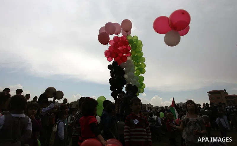Palestinians hold balloons in the colour of the national flag to mark the 25th anniversary of the Palestinian Independence Day, in Gaza city, on Nov. 17, 2013. Palestinians have marked Nov. 15 as their Independence Day s...