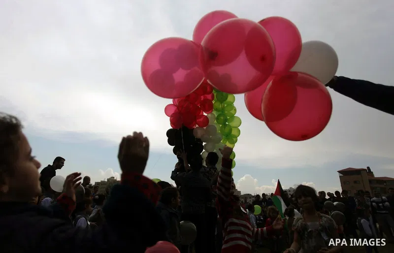 Palestinians hold balloons in the colour of the national flag to mark the 25th anniversary of the Palestinian Independence Day, in Gaza city, on Nov. 17, 2013. Palestinians have marked Nov. 15 as their Independence Day s...