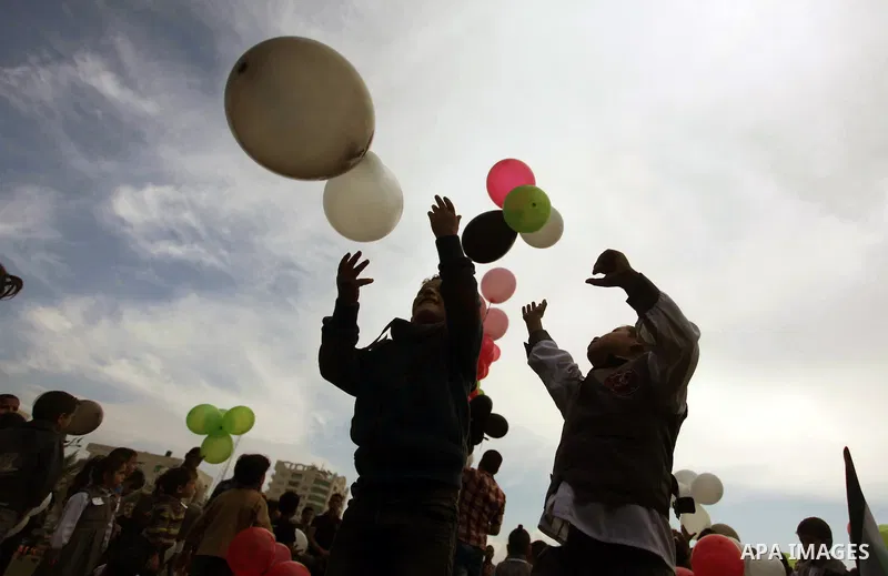 Palestinians hold balloons in the colour of the national flag to mark the 25th anniversary of the Palestinian Independence Day, in Gaza city, on Nov. 17, 2013. Palestinians have marked Nov. 15 as their Independence Day s...