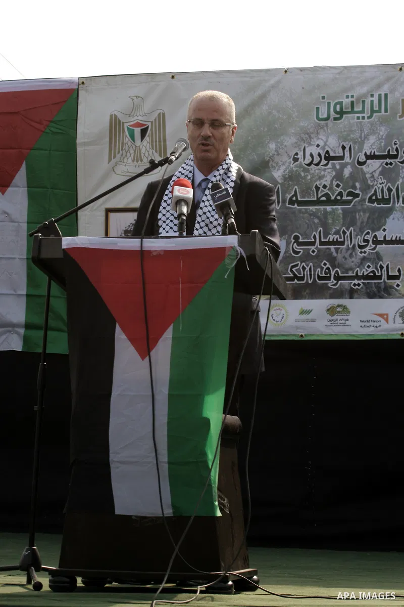 Palestinian Prime Minister Rami Hamdallah participates in the opening of olive oil festival, in the West Bank town of Salfit, southern Nablus, November 17, 2013. Photo by Nedal Eshtayah