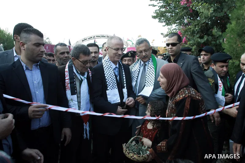 Palestinian Prime Minister Rami Hamdallah participates in the opening of olive oil festival, in the West Bank town of Salfit, southern Nablus, November 17, 2013. Photo by Nedal Eshtayah