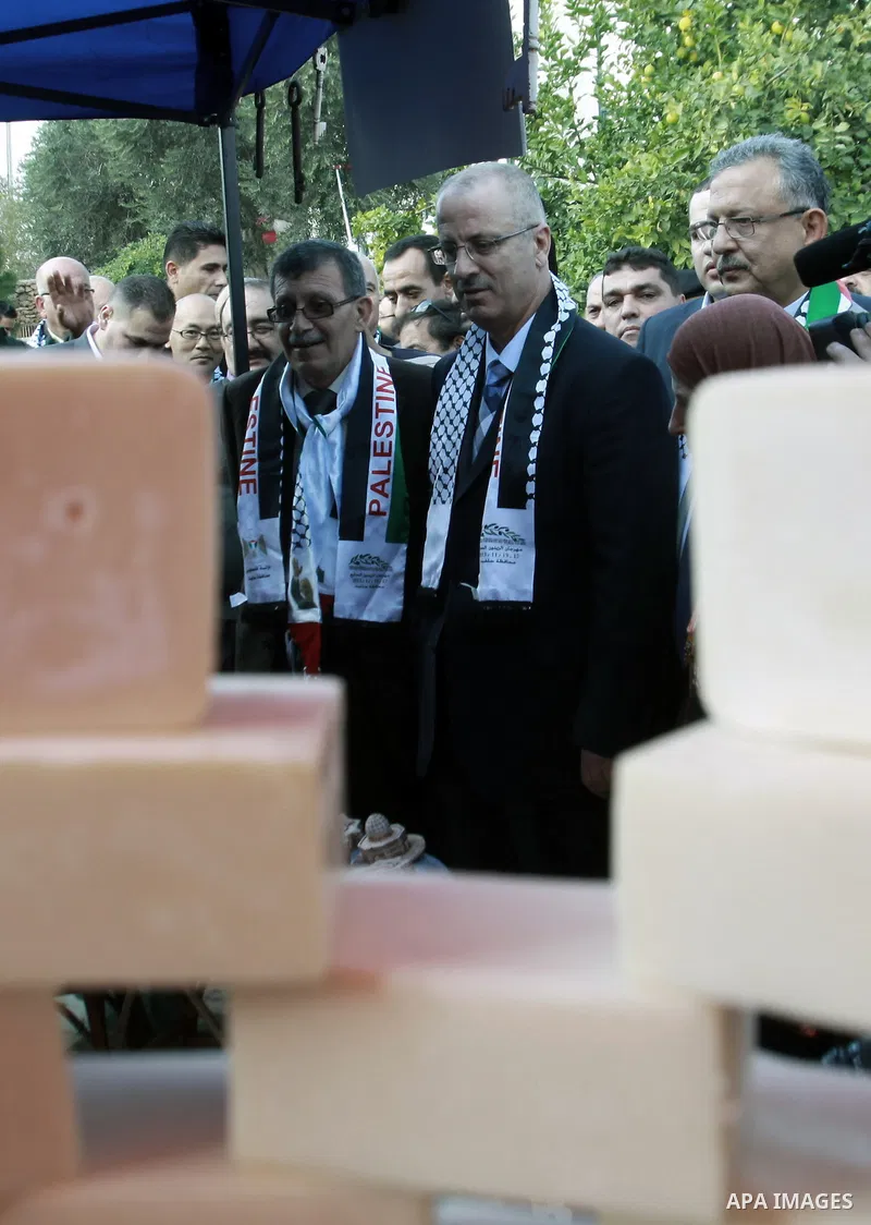 Palestinian Prime Minister Rami Hamdallah participates in the opening of olive oil festival, in the West Bank town of Salfit, southern Nablus, November 17, 2013. Photo by Nedal Eshtayah