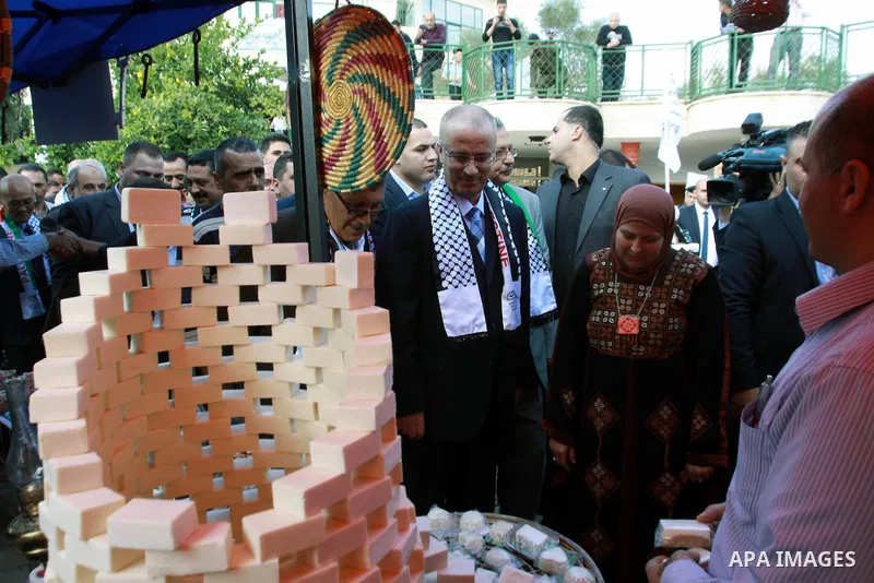 Palestinian Prime Minister Rami Hamdallah participates in the opening of olive oil festival, in the West Bank town of Salfit, southern Nablus, November 17, 2013. Photo by Nedal Eshtayah