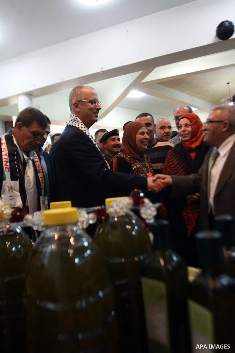 Palestinian Prime Minister Rami Hamdallah participates in the opening of olive oil festival, in the West Bank town of Salfit, southern Nablus, November 17, 2013. Photo by Nedal Eshtayah