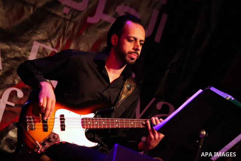 A member of "Ramses Qisses" musical band performs during the fifth concert of "Music nights in Jerusalem of Arab" festival, in Jerusalem on November 17, 2013. The festival organised by Edward Said music conservatory for...
