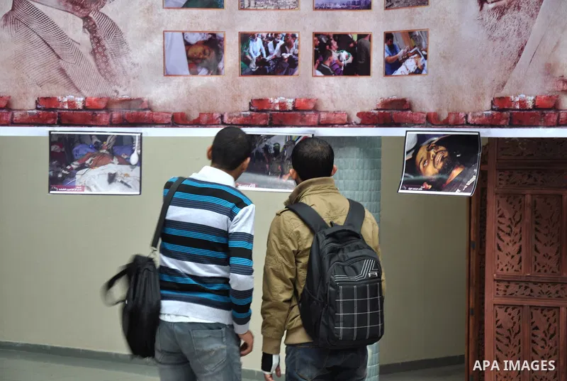 Palestinian students participate in Photo Gallery celebrations marking the first anniversary of an Israeli army operation, at the Islamic University in Gaza City November 18, 2013. Photo by Mohammed Talatene