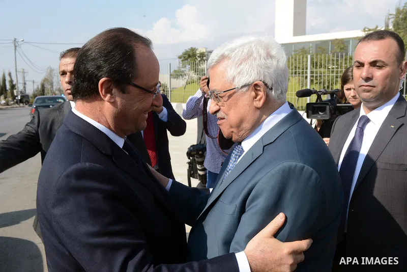 Palestinian President Mahmoud Abbas greets French President Francois Hollande as he leaves, in the West Bank city of Ramallah, on November 18, 2013. Hollande is expected to meet with Palestinian leaders for talks on trou...