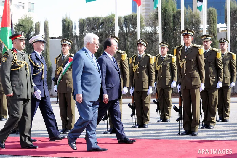 Palestinian President Mahmoud Abbas, and French President Francois Hollande walk past an honor guard during a welcoming ceremony in the West Bank city of Ramallah, on November 18, 2013. Hollande is expected to meet with...