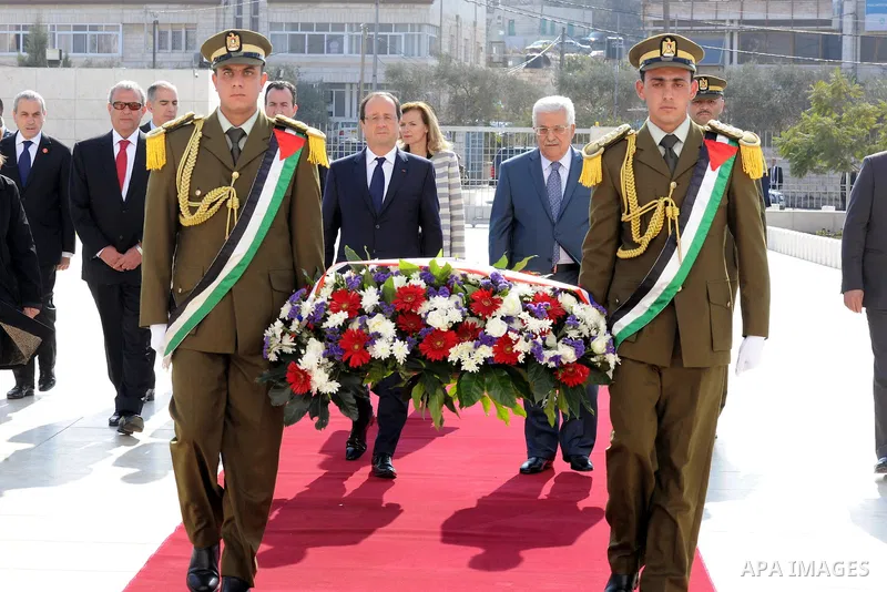Palestinian President Mahmoud Abbas, and French President Francois Hollande walk past an honor guard during a welcoming ceremony in the West Bank city of Ramallah, on November 18, 2013. Hollande is expected to meet with...