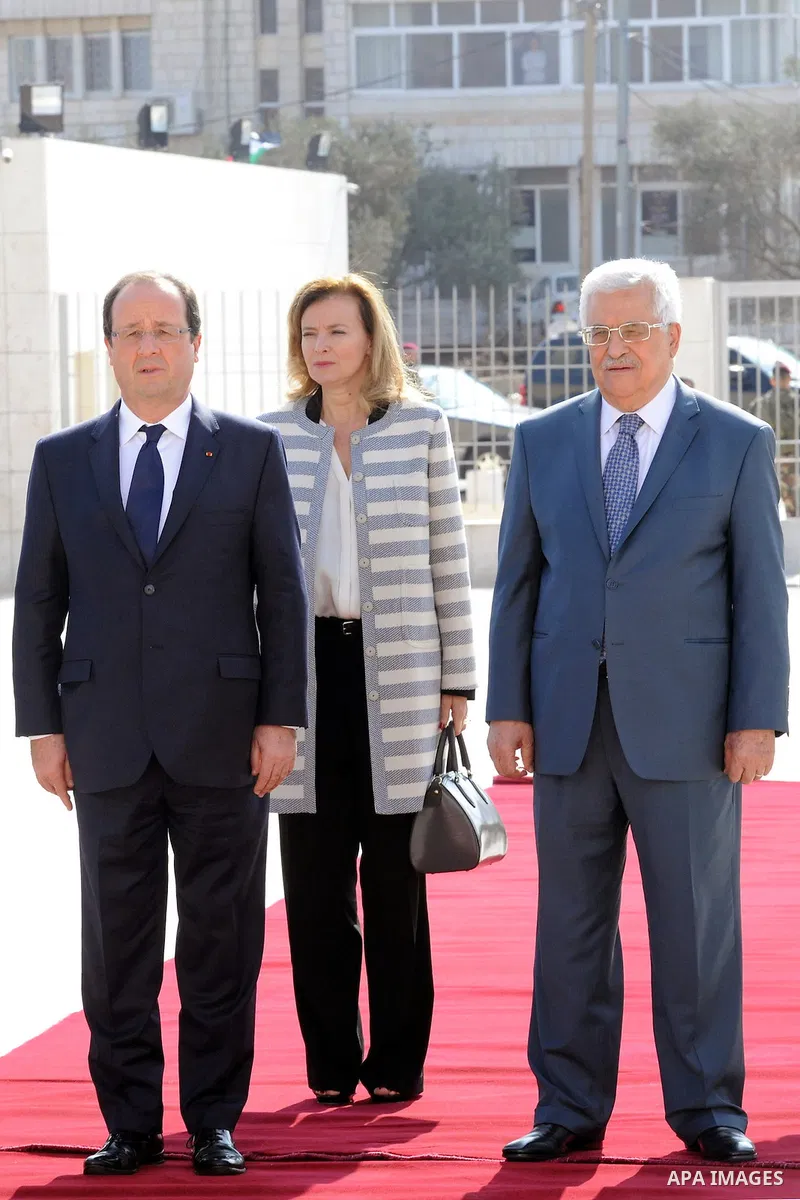 Palestinian President Mahmoud Abbas, and French President Francois Hollande walk past an honor guard during a welcoming ceremony in the West Bank city of Ramallah, on November 18, 2013. Hollande is expected to meet with...
