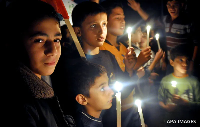 Palestinian children light candles during a rally marking ''Universal Children's Day'' calling for end the blockade on Gaza Strip, in Gaza City on November 20, 2013. Photo by Mohammed Talatene