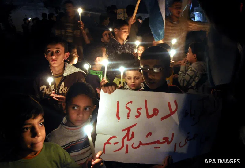 Palestinian children light candles during a rally marking ''Universal Children's Day'' calling for end the blockade on Gaza Strip, in Gaza City on November 20, 2013. Photo by Mohammed Talatene