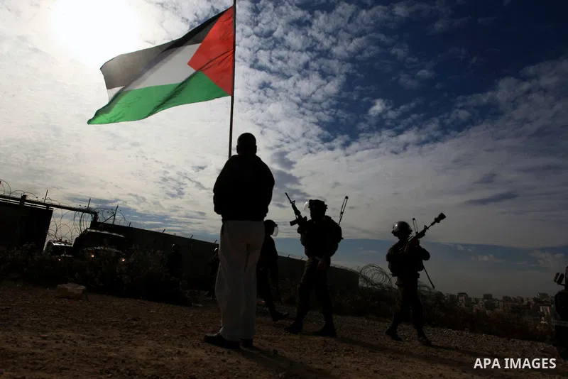 A Palestinian man argues with Israeli border policemen during the weekly demonstration against Israel's separation barrier in the West Bank village of Bilin, near Ramallah, Friday, Nov. 22, 2013. Photo by Issam Rimawi