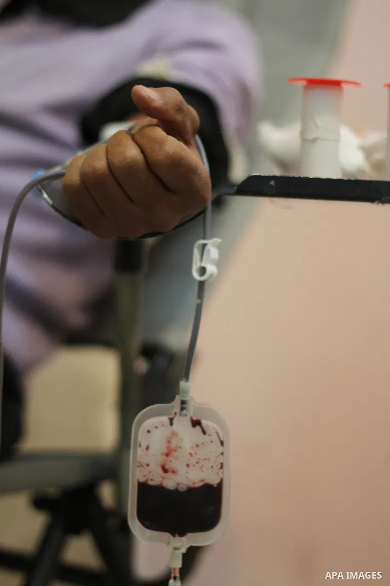 Palestinian youth donates blood during the launch of campaign " the good gathered" in the West Bank city of Ramallah on Nov. 23, 2013. Photo by Issam Rimawi