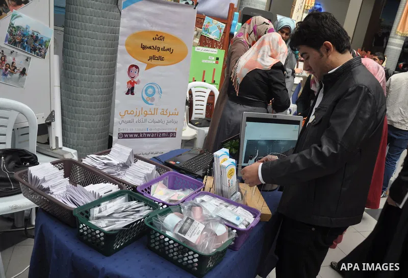 Palestinians participate in the opening of the exhibition of supporting innovative ideas in the ICT sector at Islamic university, in Gaza city, on Nov. 25, 2013. Photo by Mohammed Talatene