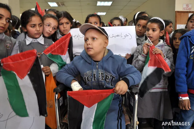 Palestinian students take part a protest against the Israeli blockade on the Gaza Strip, at al-Rantisi hospital, in Gaza city, on Nov. 26, 2013. Gaza has been almost entirely without fuel for weeks, and the resulting shu...