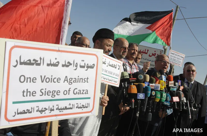 Palestinians and foreigners take part in a protest against the Israeli blockade on Gaza, at Erez crossing between Israel and Gaza Strip November 26, 2013. Israel imposed a blockade on Gaza in 2007 after Islamist group Ha...