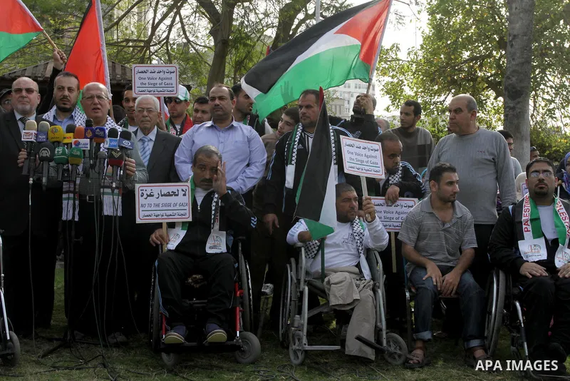 Palestinians disabled take part in a protest against the Israeli blockade on Gaza strip, in Gaza city on November 27, 2013. Israel imposed a blockade on Gaza in 2007 after Islamist group Hamas seized control of the terri...