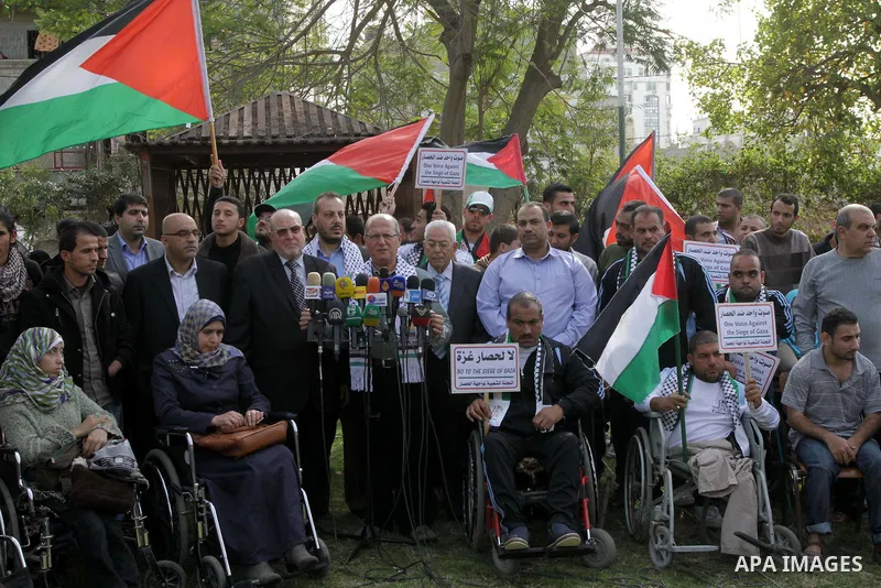 Head of the Popular Committee Jamal El-Khodari speaks in a press conference during protest with Palestinians disabled against the Israeli blockade on Gaza strip, in Gaza city on November 27, 2013. Israel imposed a blocka...