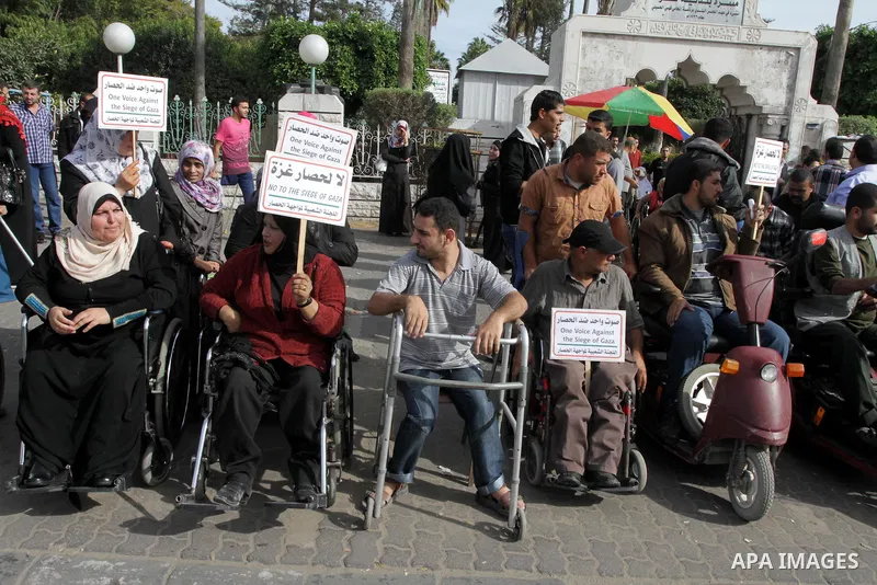 Palestinians disabled take part in a protest against the Israeli blockade on Gaza strip, in Gaza city on November 27, 2013. Israel imposed a blockade on Gaza in 2007 after Islamist group Hamas seized control of the terri...