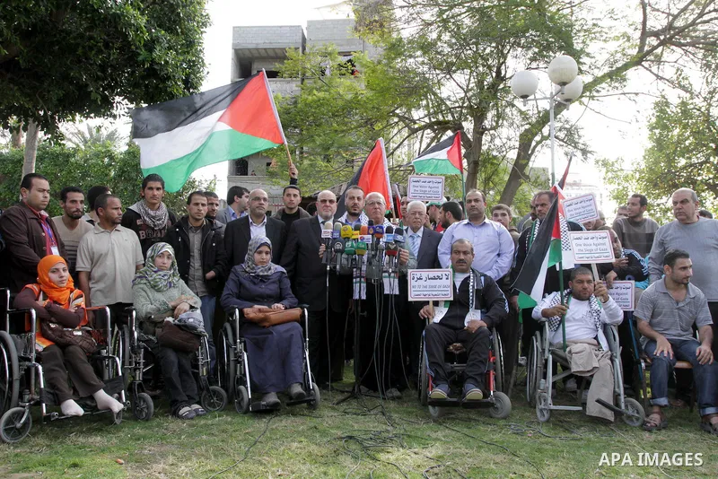 Head of the Popular Committee Jamal El-Khodari speaks in a press conference during protest with Palestinians disabled against the Israeli blockade on Gaza strip, in Gaza city on November 27, 2013. Israel imposed a blocka...