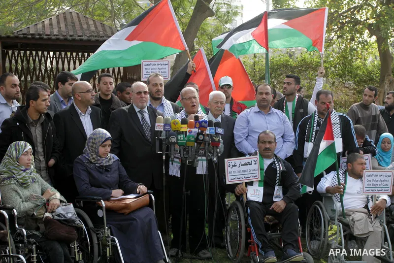Head of the Popular Committee Jamal El-Khodari speaks in a press conference during protest with Palestinians disabled against the Israeli blockade on Gaza strip, in Gaza city on November 27, 2013. Israel imposed a blocka...