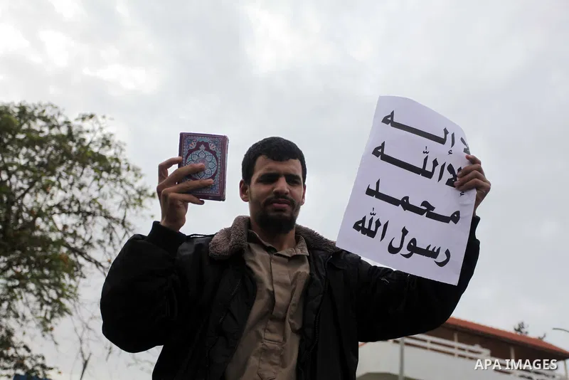 Palestinian protesters hold placards during a protest against Angola's government, in Gaza City on November 27, 2013. Angola's government on November 26, 2013 denied it had banned Islam and closed mosques in the country,...