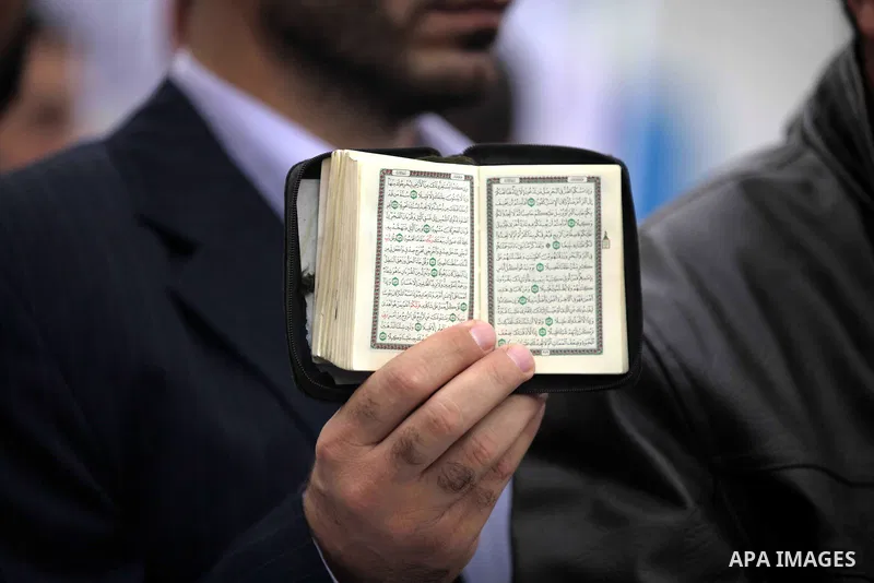 A Palestinian protester holds a copy of holy Quran during a protest against Angola's government, in Gaza City on November 27, 2013. Angola's government on November 26, 2013 denied it had banned Islam and closed mosques i...