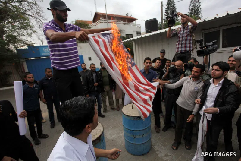 Palestinian protester burn a U.s flag during a protest against Angola's government, in Gaza City on November 27, 2013. Angola's government on November 26, 2013 denied it had banned Islam and closed mosques in the country...