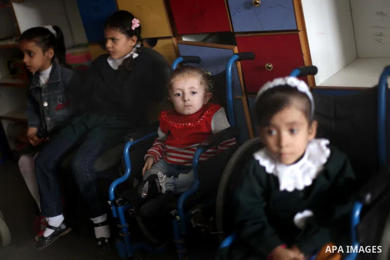 Palestinian disabled children take part in a class at a school of rehabilitation in Gaza City on November 27, 2013. The school founded since 1993 aims to provide educational services, therapeutic, psychological and leisu...