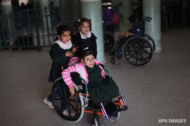 Palestinian disabled children take part in a class at a school of rehabilitation in Gaza City on November 27, 2013. The school founded since 1993 aims to provide educational services, therapeutic, psychological and leisu...