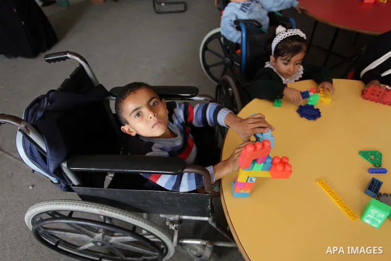 Palestinian disabled children take part in a class at a school of rehabilitation in Gaza City on November 27, 2013. The school founded since 1993 aims to provide educational services, therapeutic, psychological and leisu...