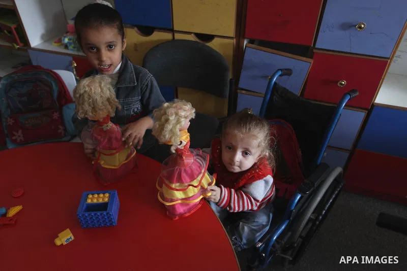 Palestinian disabled children take part in a class at a school of rehabilitation in Gaza City on November 27, 2013. The school founded since 1993 aims to provide educational services, therapeutic, psychological and leisu...