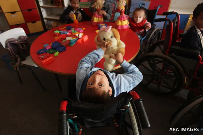 Palestinian disabled children take part in a class at a school of rehabilitation in Gaza City on November 27, 2013. The school founded since 1993 aims to provide educational services, therapeutic, psychological and leisu...