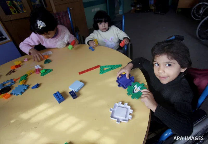 Palestinian disabled children take part in a class at a school of rehabilitation in Gaza City on November 27, 2013. The school founded since 1993 aims to provide educational services, therapeutic, psychological and leisu...